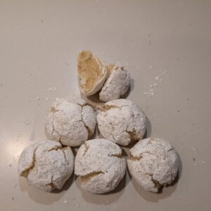 Classic amaretti cookies with a powdered sugar finish, styled simply to highlight their soft, chewy texture