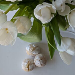 Classic amaretti cookies with a powdered sugar finish, styled simply to highlight their soft, chewy texture