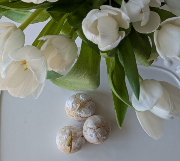 Classic amaretti cookies with a powdered sugar finish, styled simply to highlight their soft, chewy texture
